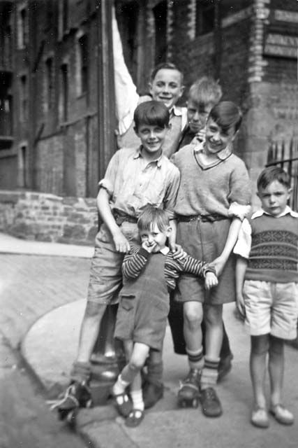 an old black and white photo of children on skateboards