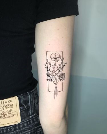 a woman with a flower tattoo on her arm