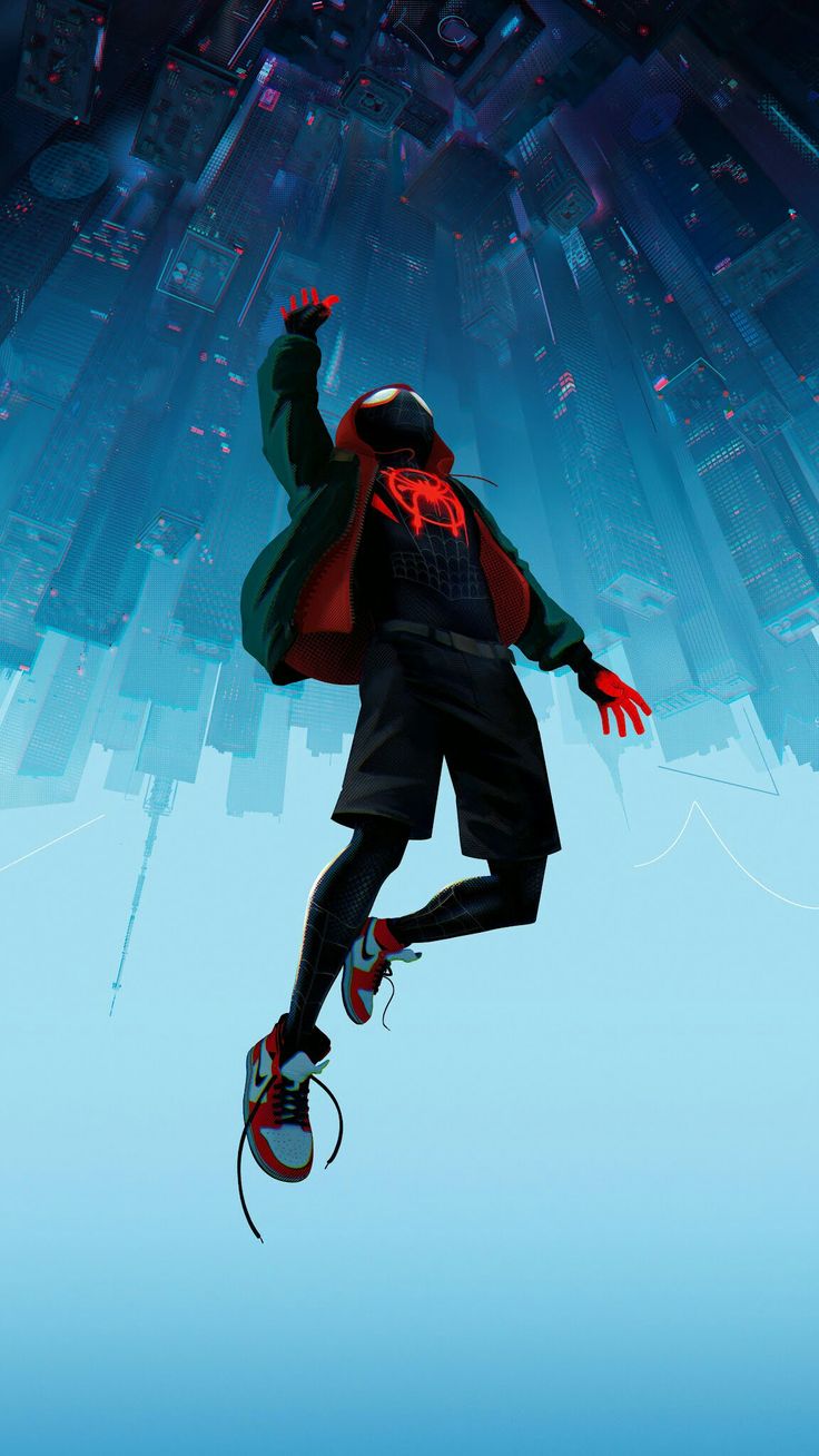 a man flying through the air while wearing a red and black jacket on top of his head