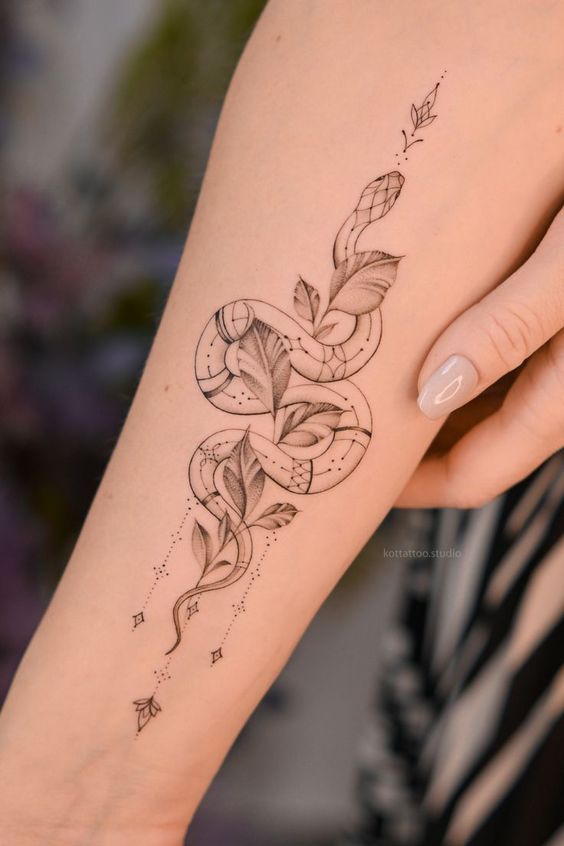 a woman's arm with a tattoo design on the left side of her body