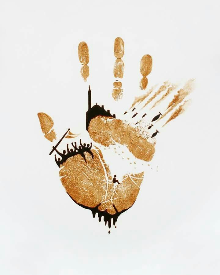 an image of a hand print on the ground with paint splatters all over it