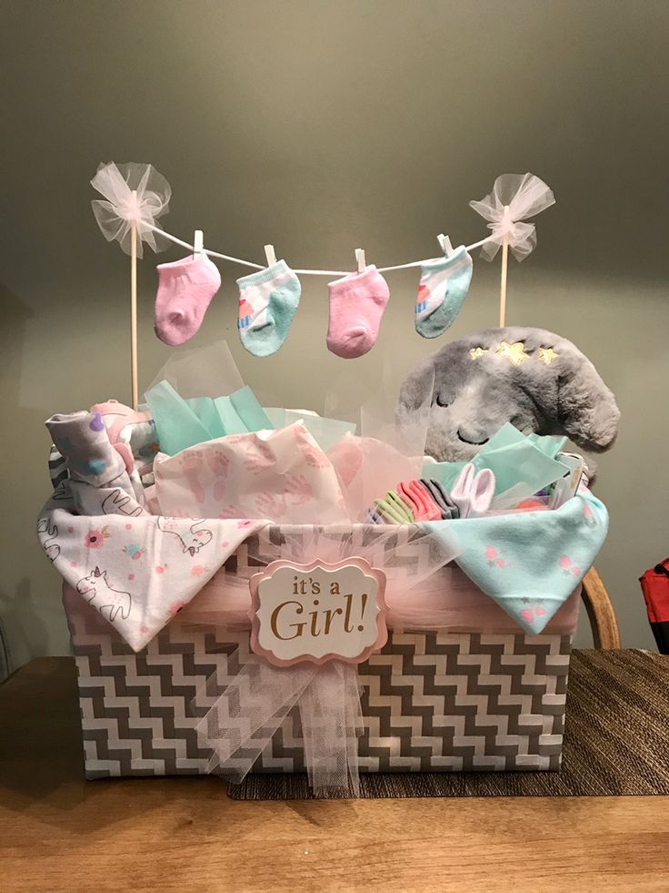 a gift basket filled with baby items on top of a table