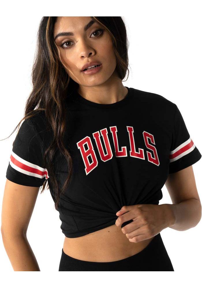 Let everyone know who you root for in this Chicago Bulls Black Crop Short Sleeve T-Shirt! This Chicago Short Sleeve Tee features a screen print team name on center chest and team logo on back. Soft hand, Finished hemline, Sleeve stripe, Short sleeve, 52% Cotton, 48% Modal, 4 Black Fitted Top With Contrast Stripes, Fitted Black Top With Contrast Stripes, Casual Black Top With Striped Hem, Casual Fitted Top With Striped Hem, Black Summer Tops With Striped Hem, Black Summer Top With Striped Hem, Black Short Sleeve Top With Striped Hem, Black Cotton Tops With Striped Hem, Black T-shirt With Contrast Stripes