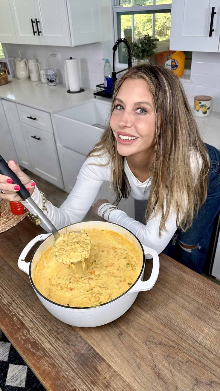 a woman sitting at a table with a bowl of food