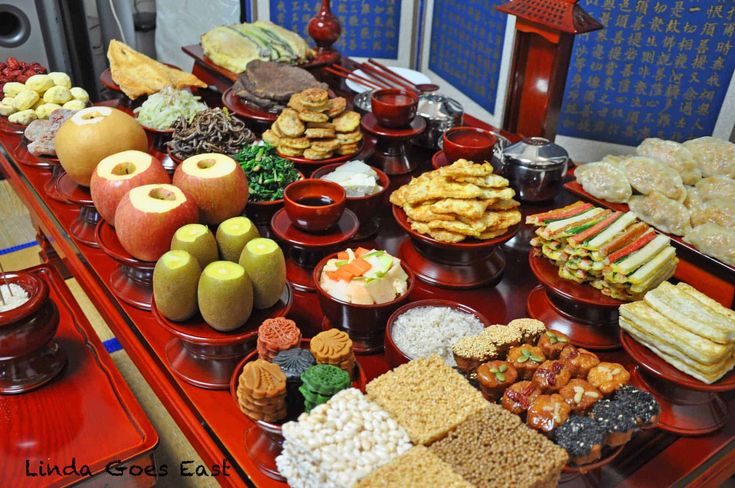 an assortment of food is displayed on a red table