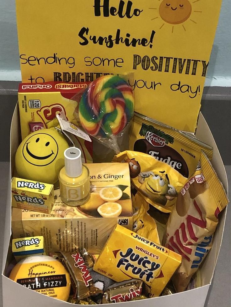 a box filled with candy and candies next to a sign that reads hello sunshine sending some positivity your day