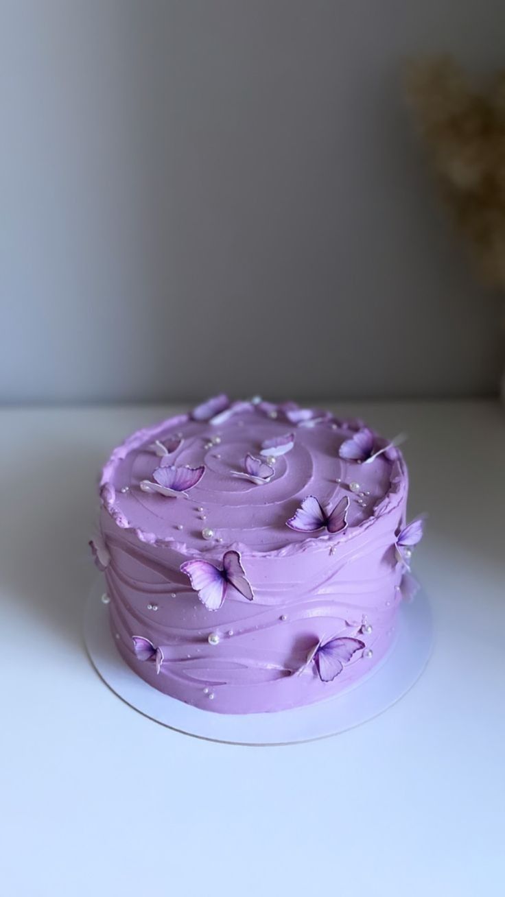 a purple cake sitting on top of a white table