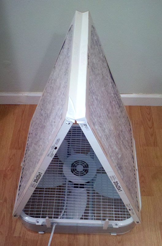 an air conditioner sitting on top of a hard wood floor next to a wall