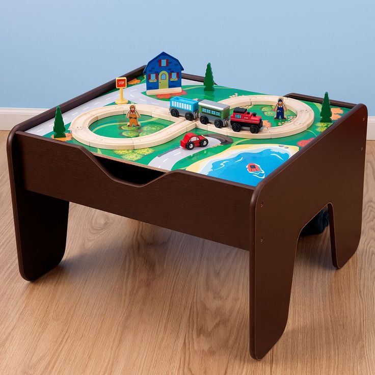 a child's wooden table with colorful tiles on it