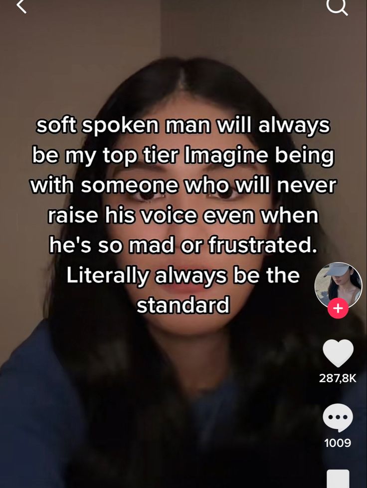 a woman with long black hair is looking at the camera and has an interesting message on her face