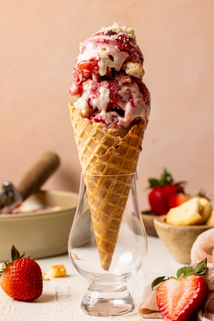 an ice cream cone with strawberries and other desserts