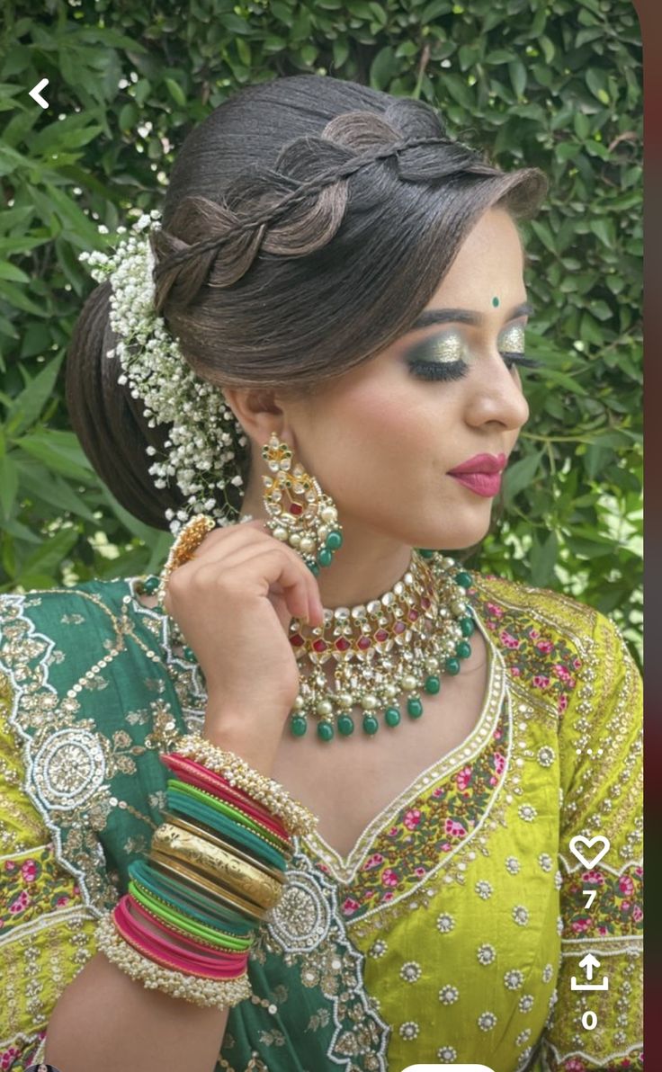 a woman in green and yellow outfit with jewelry