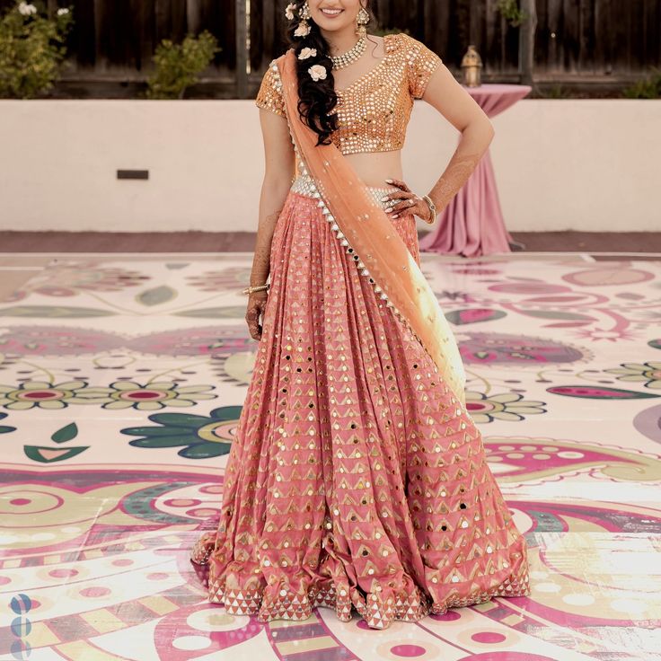 Orange And Peach Lehenga With Skirt, Blouse, And Dupatta. Perfect For A Wedding Or Sangeet Event! Orange Mirror Work Dupatta For Reception, Peach Traditional Wear With Mirror Work, Peach Traditional Wear With Mirror Work For Diwali, Bollywood Style Orange Saree For Reception, Orange Bollywood Saree For Reception, Peach Traditional Wear For Diwali Reception, Peach Traditional Wear For Reception And Diwali, Floor-length Peach Choli For Reception, Bollywood Style Peach Choli For Reception