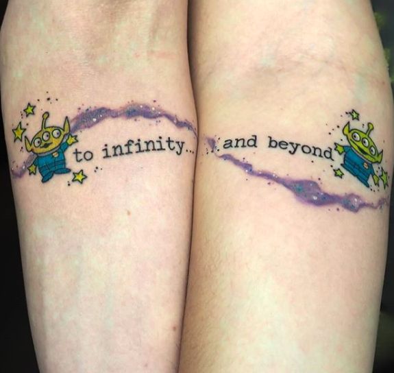 two people with tattoos on their arms that say to infinitity and beyond