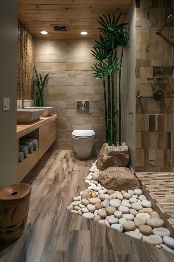 a bathroom with rocks and plants on the floor