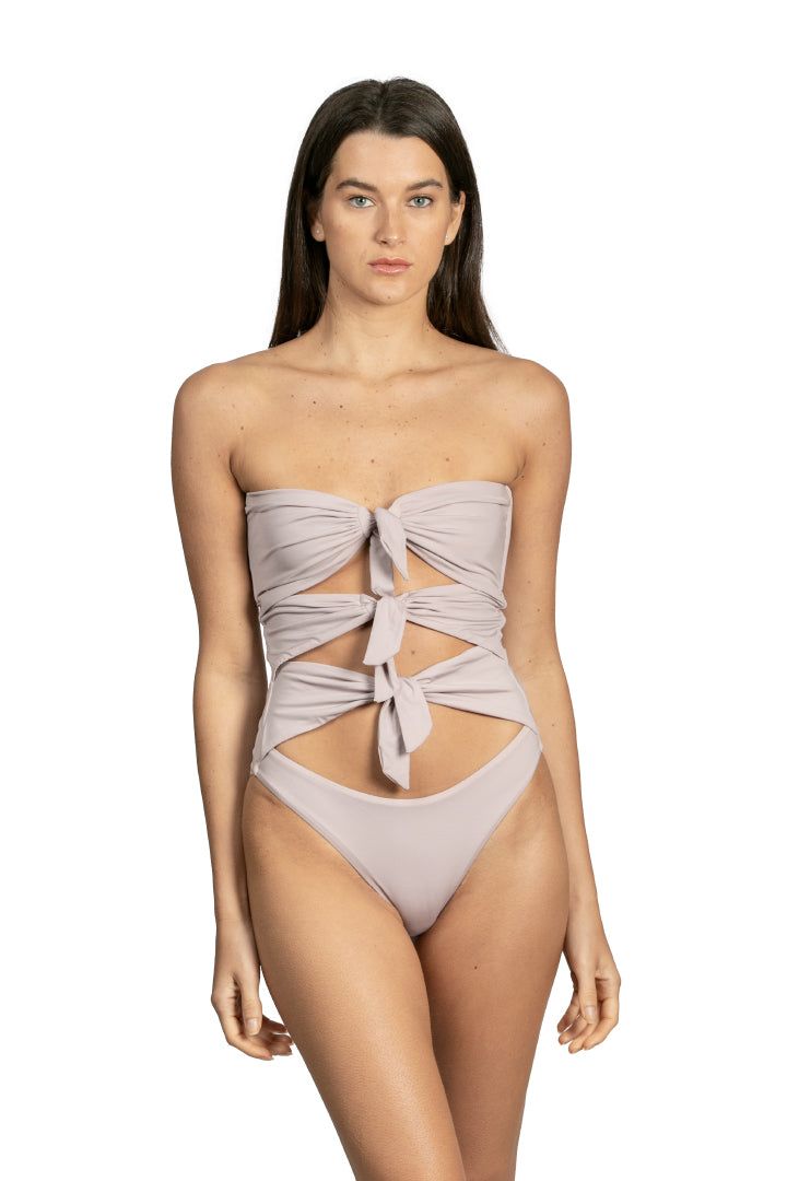 Santa Cruz by Sanlier is a one-piece that features multiple ties in the front for a playful, unique look. Plus, the strapless design adds an alluring element to this otherwise innocent piece. It’s equally subtle and sexy while offering plenty of support. Chic Bandeau Swimwear, Chic Strapless Swimwear For Evening, Elegant Bandeau Swimwear For Spring, Elegant Bandeau Party Swimwear, Elegant Strapless Swimwear For Spring, Chic Strapless Tube Top For Poolside, Elegant Strapless Swimwear For Evening, Elegant Strapless Evening Swimwear, Chic Strapless Party Swimwear