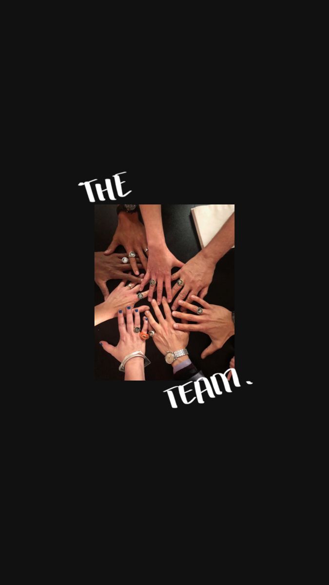 the team is holding their hands together to form a circle on top of each other