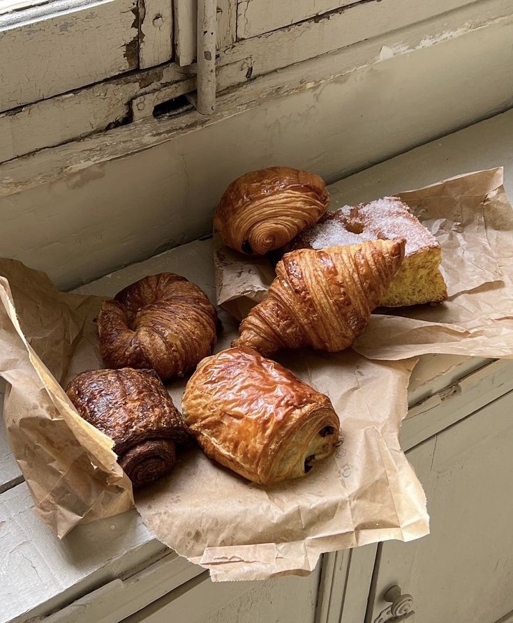 some croissants and pastries are sitting on the counter