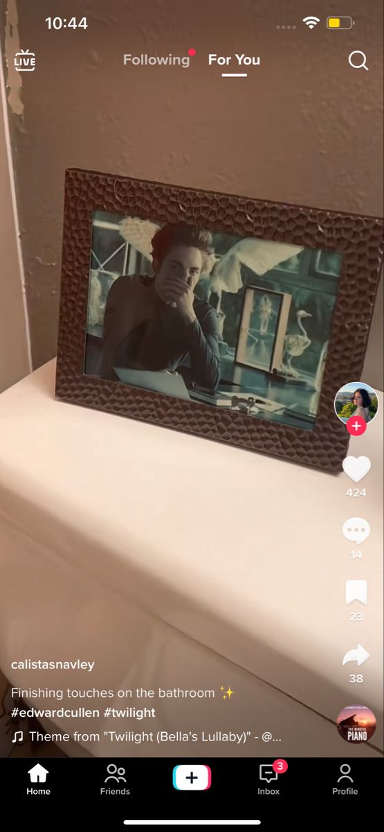 a photo frame sitting on top of a bed with an instagram message below it