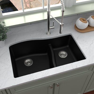 a double black kitchen sink sitting on top of a counter