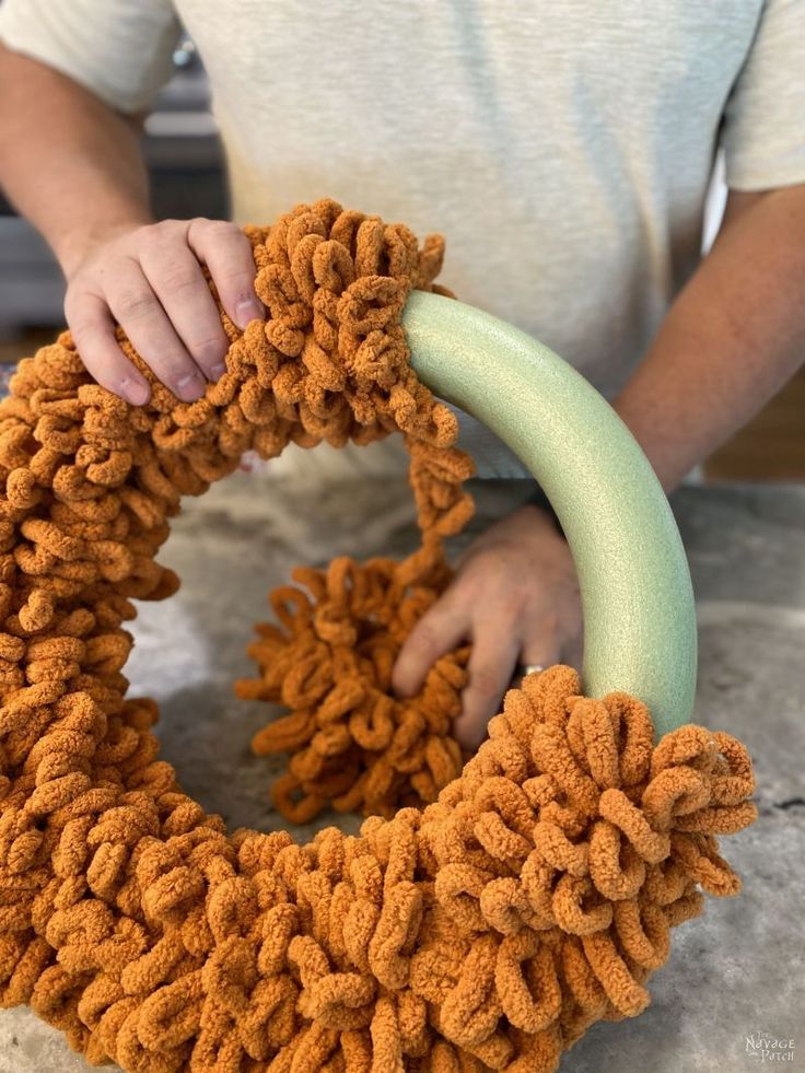 someone is making a wreath out of yarn