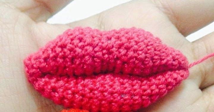 a crocheted lip is shown in the palm of someone's hand