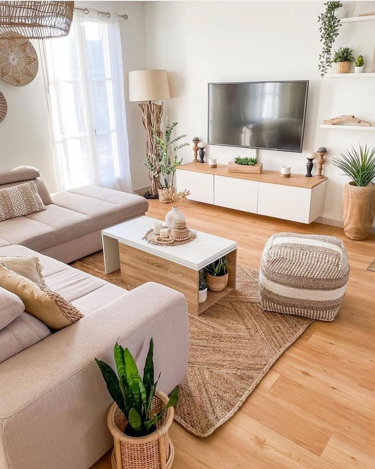 a living room filled with furniture and a flat screen tv on top of a wooden table