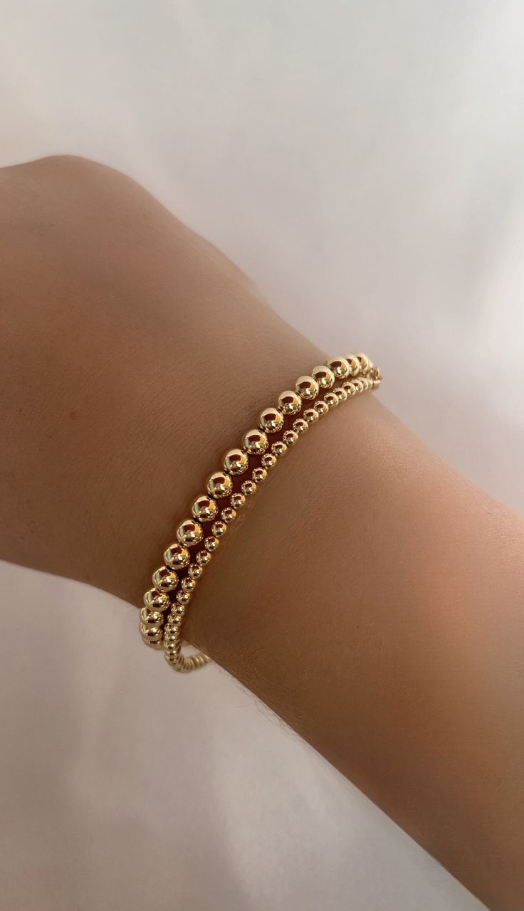 Handmade 14k Gold filled bracelets, perfect everyday wear or special occasions and a wonderful  Gift for Mom, Wife, Friend, Sister, Grandmother and Daughter. HOW TO ORDER 1. First, select your desired metal in the drop down box 1. Then, select your bracelet size and add to cart! BRACELET MEASURING GUIDE: Average Women's Sizing: 5-6.5 inches = extra small 6.5-7 inches = small 7-8 inches = medium 8 inches+ = large *We recommend ordering a size that is roughly 1/2 inch - 1 inch larger than one's ac 14k Gold Bracelet With Gold Beads As Gift, Classic Gold Stackable Bracelet For Gift, Classic Stretch Bracelet With Polished Beads As Gift, Everyday Gold Beaded Bracelet Jewelry, Classic Stretch Bracelet With Polished Beads For Gift, Classic Gold Stackable Bracelet Gift, Adjustable 14k Gold Beaded Bracelets With Tiny Beads, Everyday 14k Gold Hand-strung Beaded Bracelets, Classic Stackable Gold Bracelet For Gift