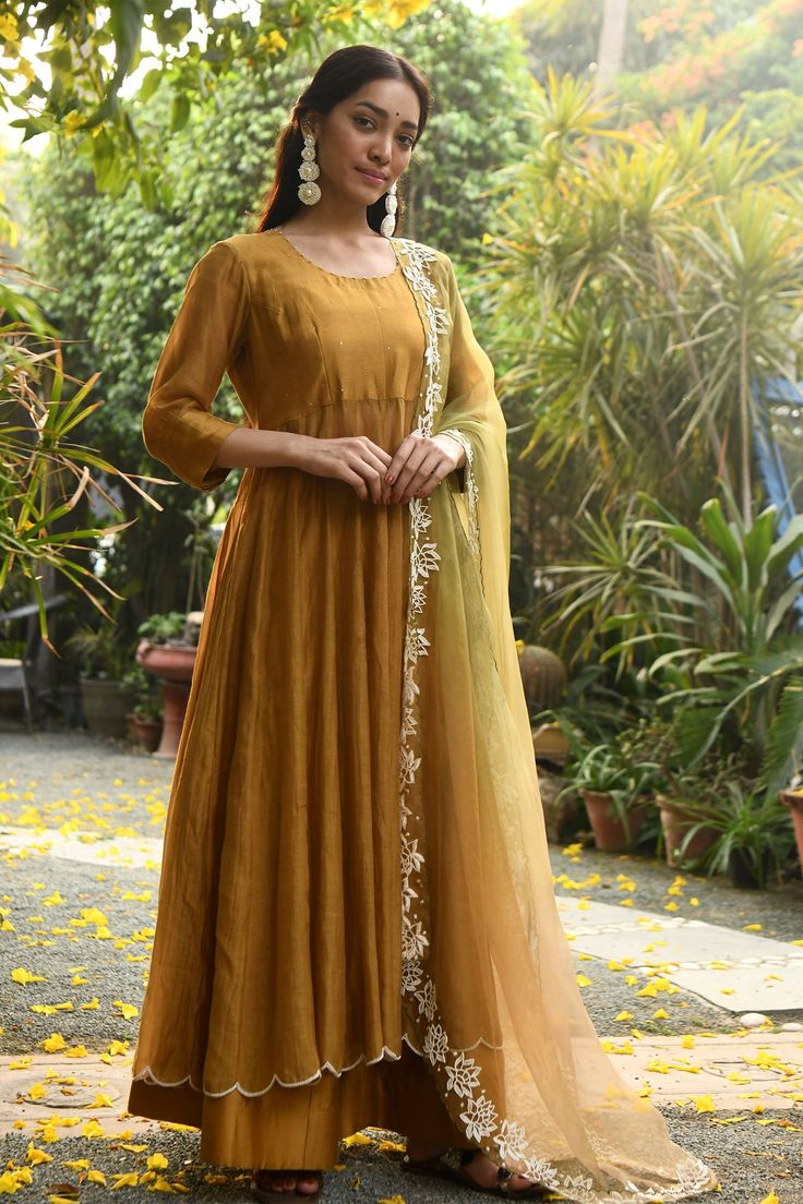 Mustard anarkali with scallop border and bead work. Paired with palazzo and floral embroidered dupatta.
Component: 3
Neckline: Round
Sleeve Length: Three quarter
Fabric: Handloom Chanderi, Organza
Color: Yellow
Embroidered dupatta - Aza Fashions Mustard Anarkali, Chanderi Anarkali, Scallop Border, Embroidered Dupatta, Fashion App, Agra, Kurti Designs, Set For Women, Anarkali