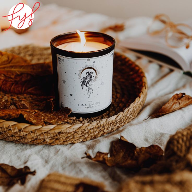 a candle sitting on top of a wicker tray