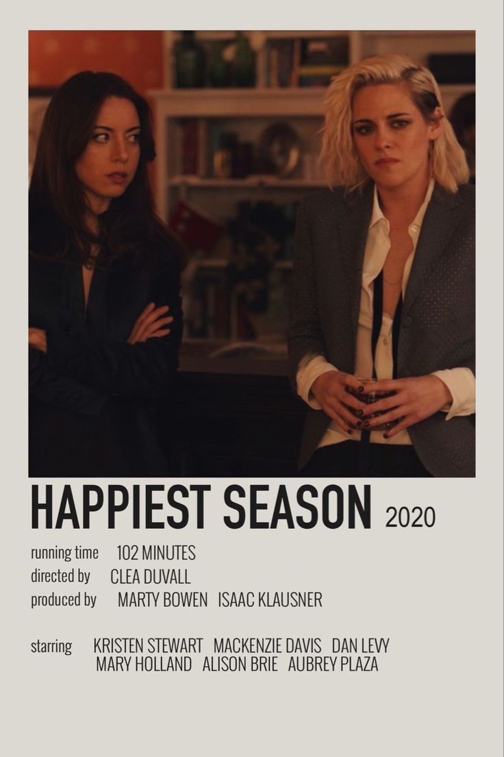 two women standing next to each other in front of a book cover with the words happiest season on it