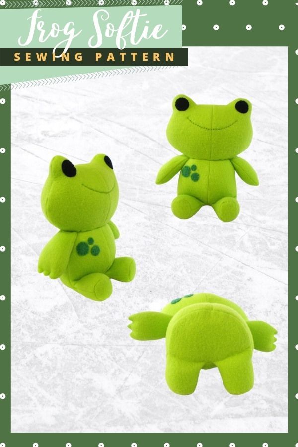 three green stuffed animals sitting next to each other on a snow covered ground with polka dots