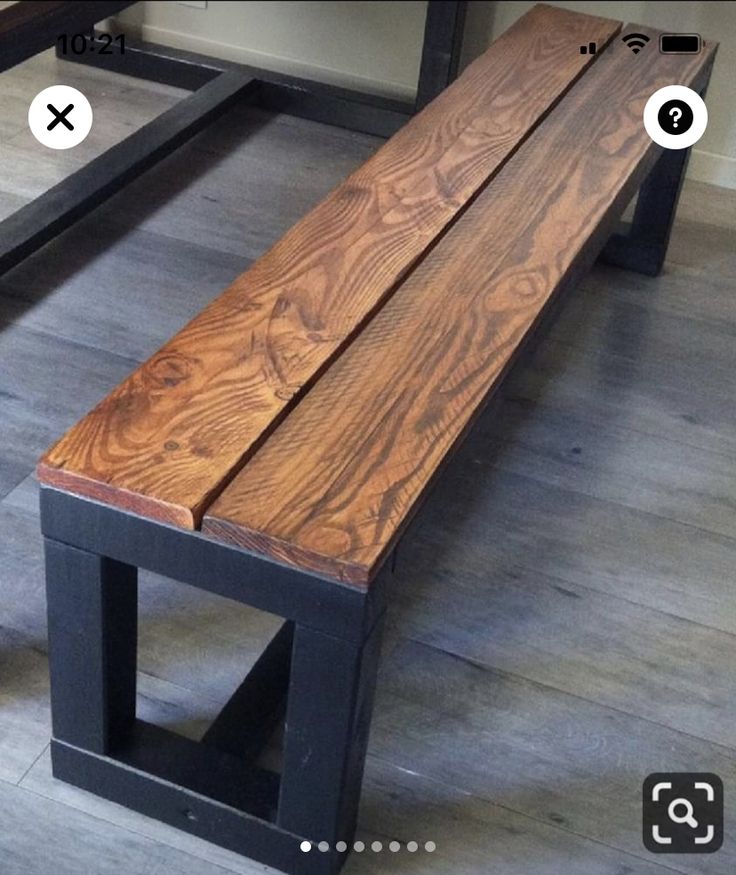 a wooden bench sitting on top of a hard wood floor