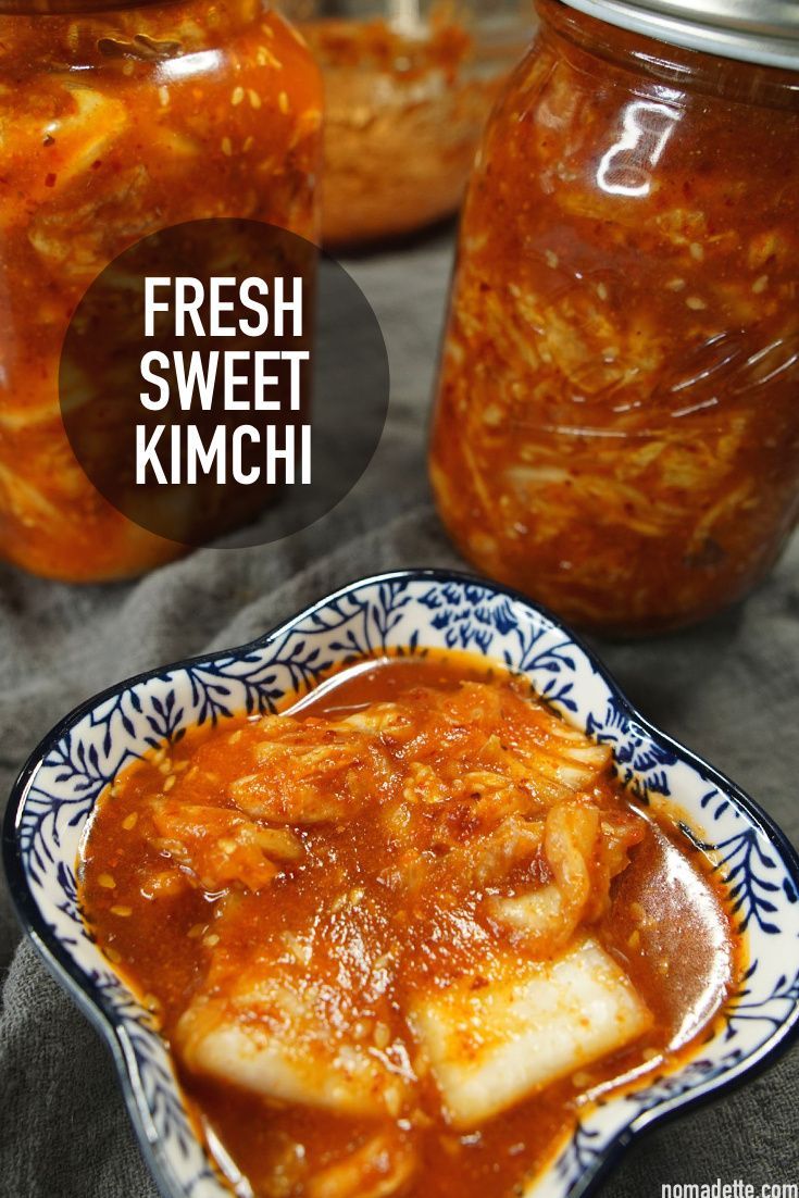 fresh sweet kimchi is in a bowl next to some jars with food on them