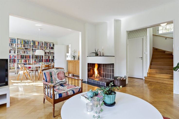 a living room filled with furniture and a fire place