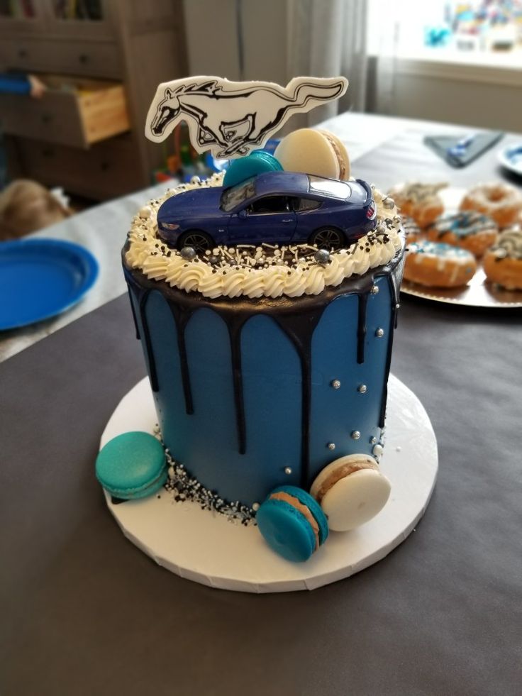 a blue and white cake with cars on it