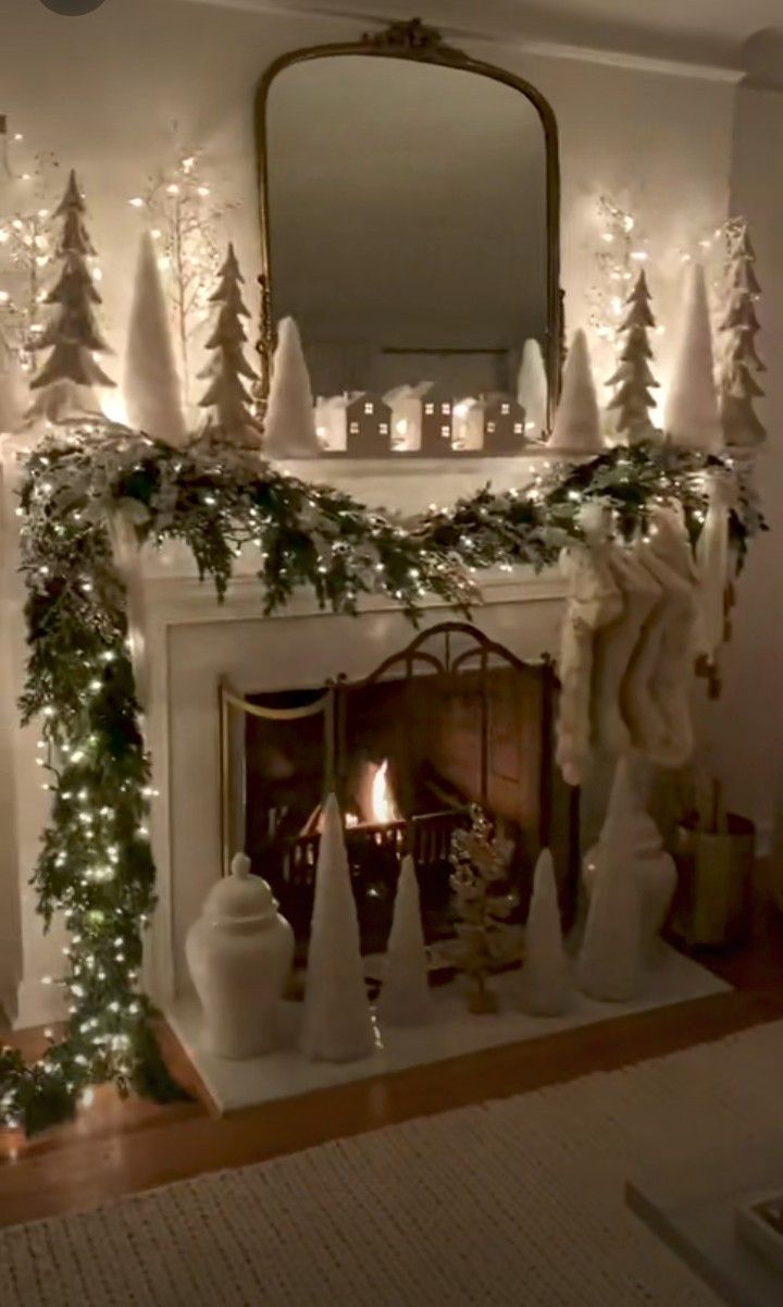 a fireplace decorated for christmas with lights and garland