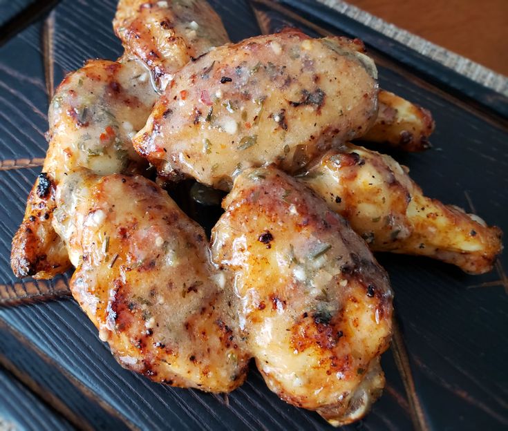 grilled chicken wings are sitting on a grill