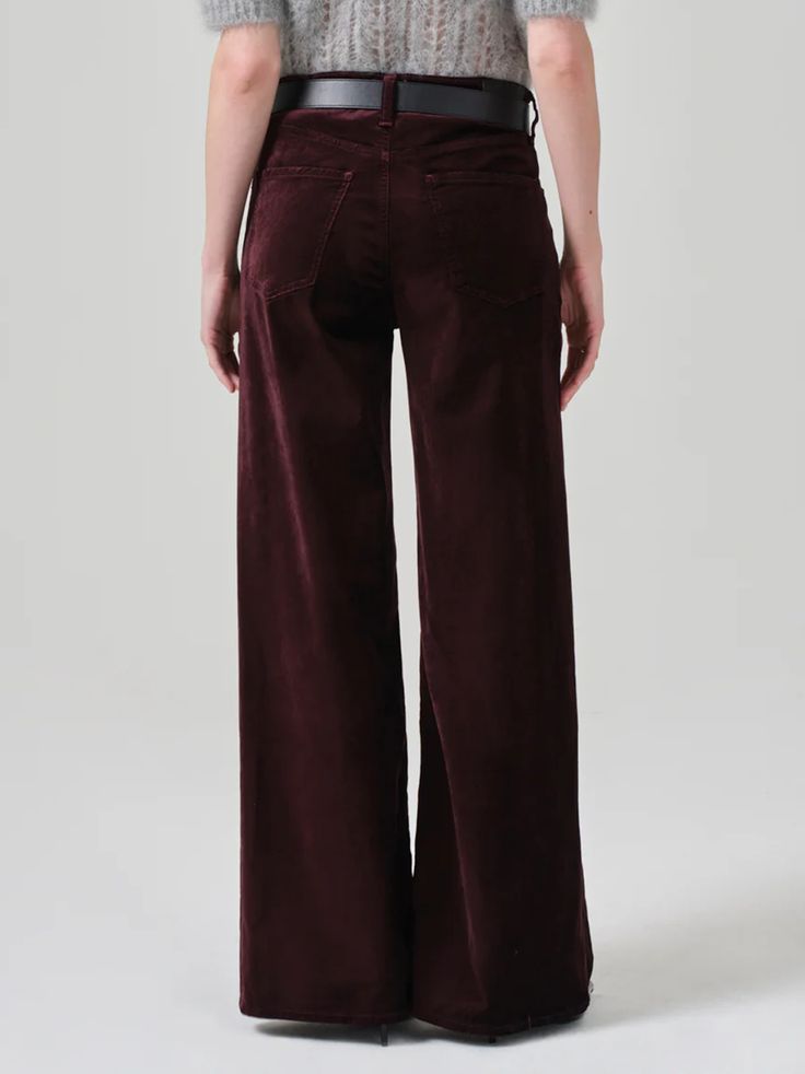 Amy Says... The Lolli features an ultra-flattering mid-rise waist that sits higher up on the hip with an easy, relaxed wide leg. The 32" inseam lengthen the leg for a look that can be easily dressed up or down. Looks Like: Saturated burgundy with a finished hem. Feels Like: Stretch velvet with a super smooth hand. This fit is true to size. Closure: Zip Fly Rise: 11" Inseam: 32" Leg Opening: 24 1/2" Model is 5'10" and wearing a size 27 Wash: Burgundy Fabric: 54% Cotton 44% Rayon 2% Spandex Made i Burgundy Fabric, Coat Shoes, Vacation Accessories, Velvet Trousers, Save The Duck, Suit Shoes, Polo Sweater, Baggy Pant, Stretch Velvet