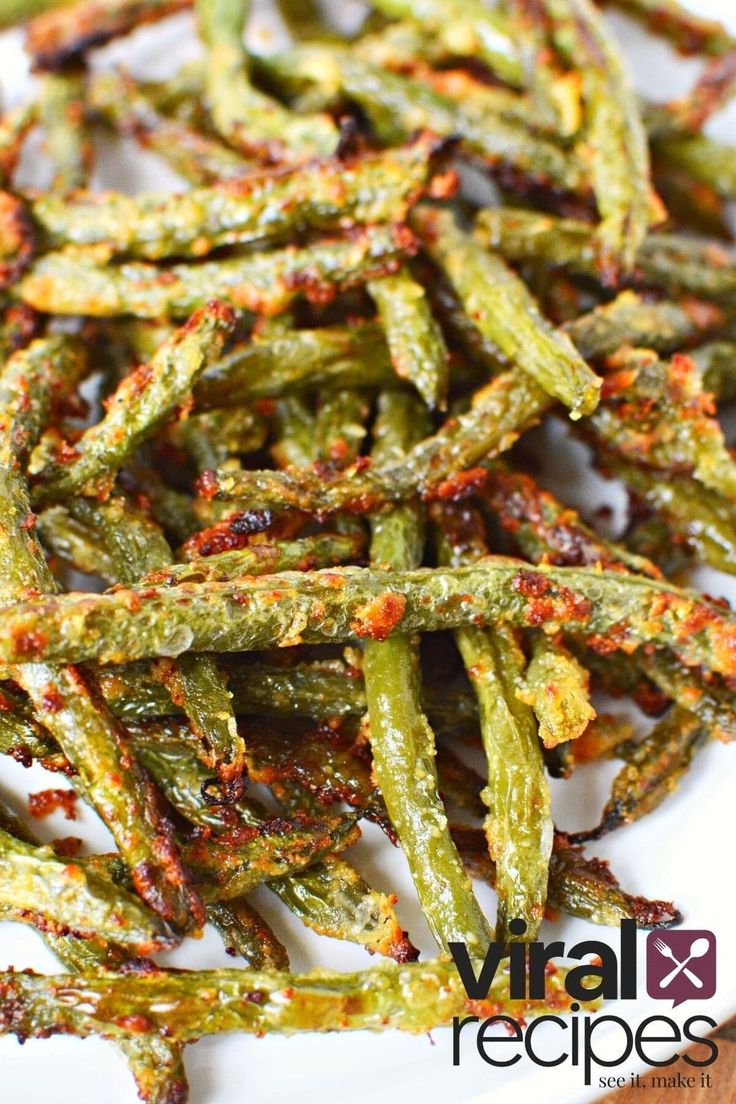 fried green beans on a white plate with red pepper sprinkled on top and the words, virtual recipes