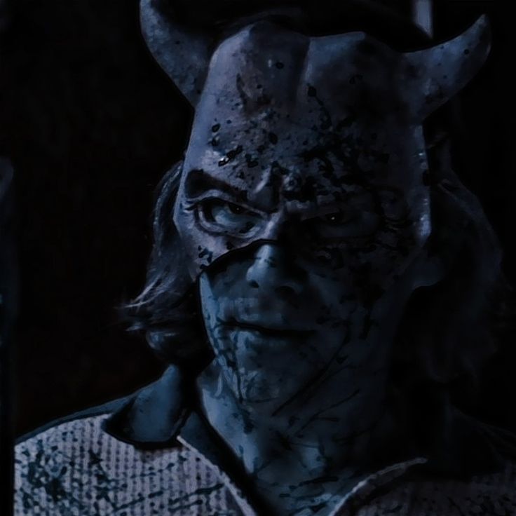 an evil looking man with horns on his head