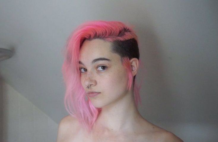 a young woman with pink hair and piercings