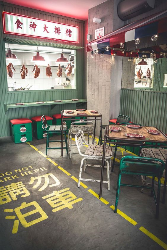 the inside of a restaurant with tables and chairs in front of windows that have chinese writing on them