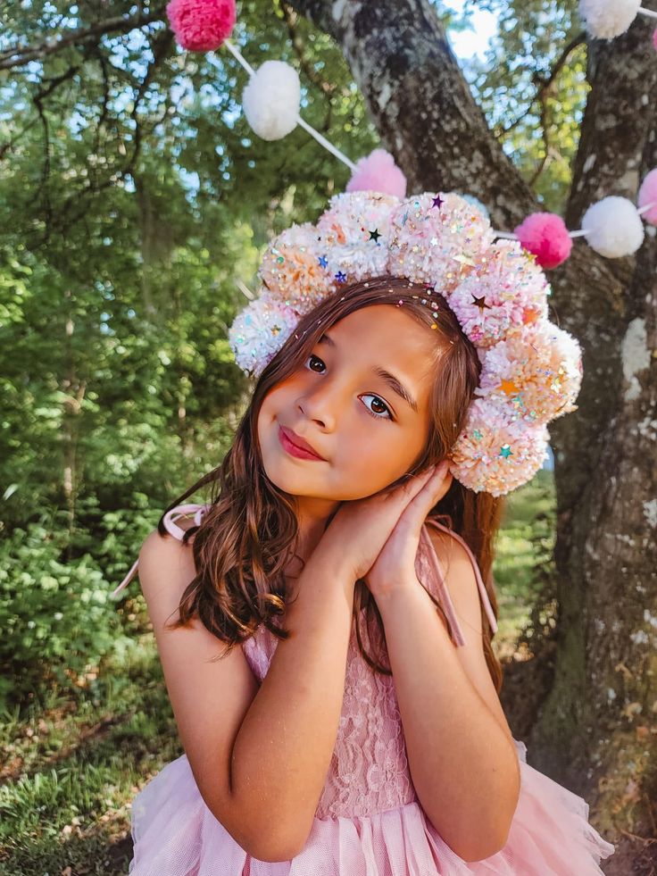 Get ready to add some sparkle to your outfit with our Pompom yarn sequins glitter metal band over the top fascinator! This unique headpiece features a playful blend of textures and materials, making it the perfect statement accessory for any occasion. Throw it on and get ready to turn some heads! Pompom Headpiece, Whimsical Crown-shaped Headband For Festivals, Summer Pink Feathered Headpieces, Pink Whimsical Headband Headpiece, Whimsical Pink Headband Fascinator, Yarn Pom Pom, Over The Top, Metal Bands, Fascinator