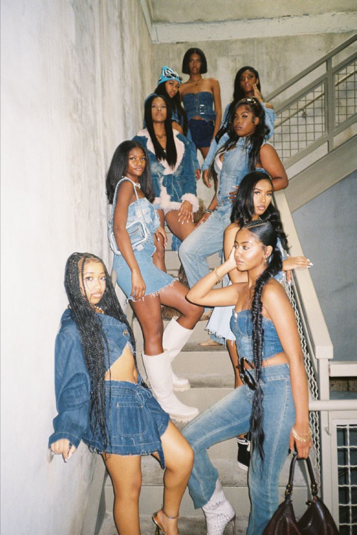 a group of women standing next to each other on stairs