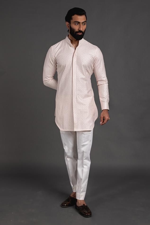 Pink short kurta with embroidered detail and mandarin collar, edge cut hem. Paired with cotton silk pant.
Component: 2
Pattern: Embroidered
Neckline: Mandarin
Sleeve Type: Cuff Sleeves
Fabric: Chanderi Silk, Cotton Silk
Color: Pink
Other Details: 
Cuff sleeves
Occasion: Destination Wedding - Aza Fashions Silk Kurta Set, Silk Pant, Kurta Set For Men, Short Kurta, Silk Kurta, Nehru Jackets, Embroidered Neckline, Silk Pants, Kurta Set