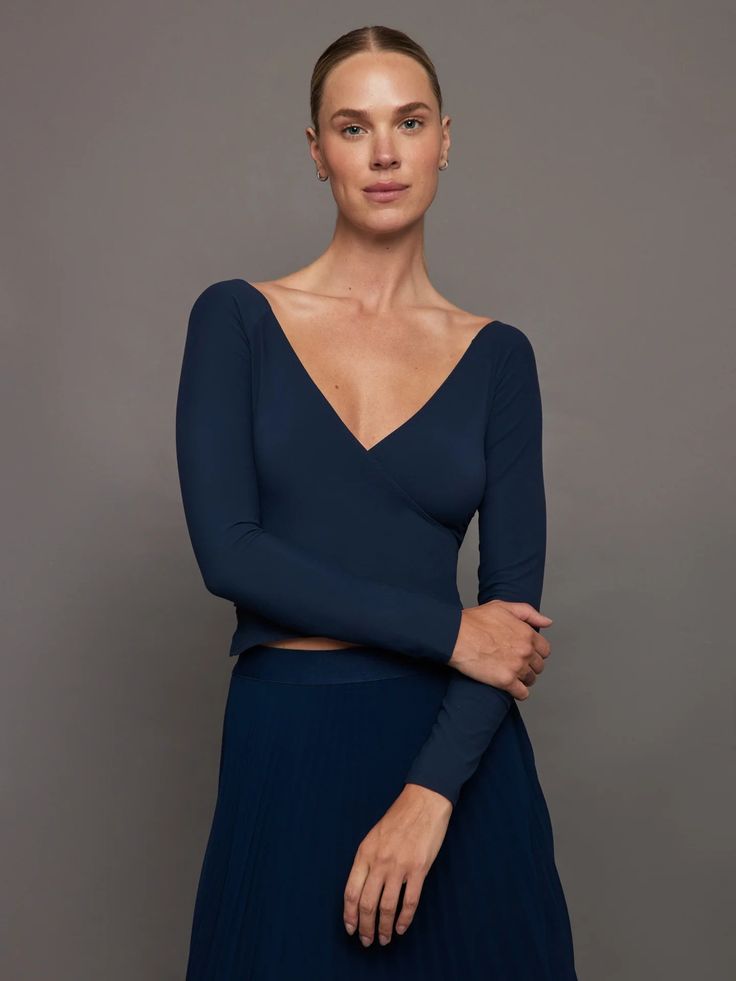 The Long Sleeve Wrap Top is a chic, slightly cropped style that encases you in our buttery soft Melt fabric that you know and love. It features an open ballet back and a front mock-wrap detail. With it's clean lines and luxe feel, this piece will elevate any look.