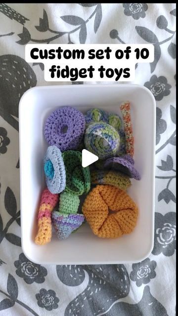 a white bowl filled with lots of crochet toys