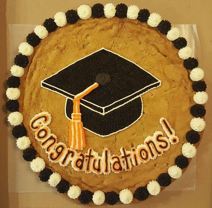 a decorated graduation cake with the words congratulations on it and a tasseled cap