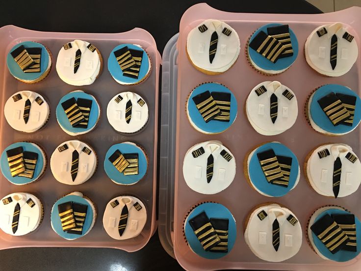 two trays with cupcakes decorated to look like ties and suits on them